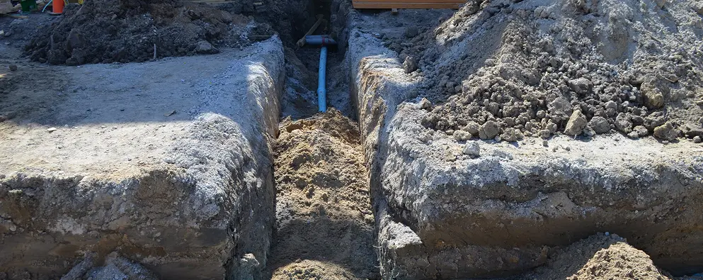 Excavated trench with visible pipeline