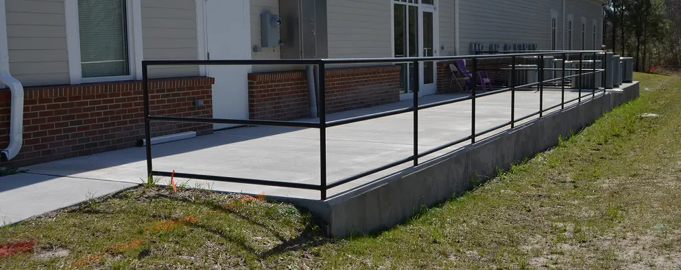 Building ramp with black metal railing