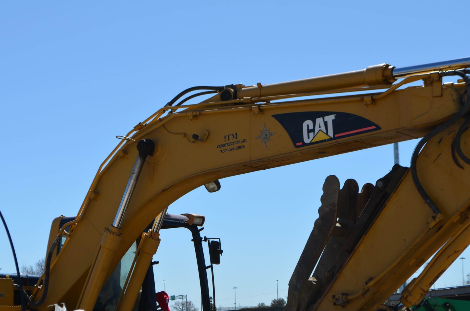 Construction excavator arm under clear sky